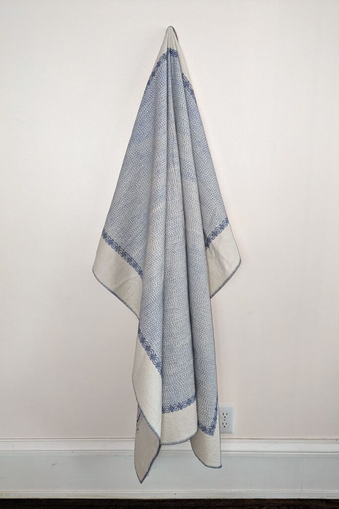 Throw quilt- blue on white Muslin with kantha stitching