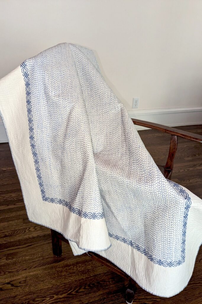 Throw quilt- blue on white draped Muslin with kantha stitching